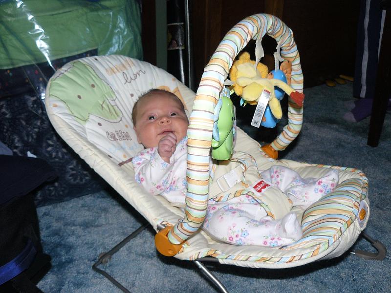 P1010553.JPG - Hailee enjoys her bouncer with toys